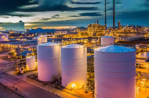 Aerial view oil terminal is industrial facility for storage tank of oil and petrochemical industry products ready for transport to further storage facilities.